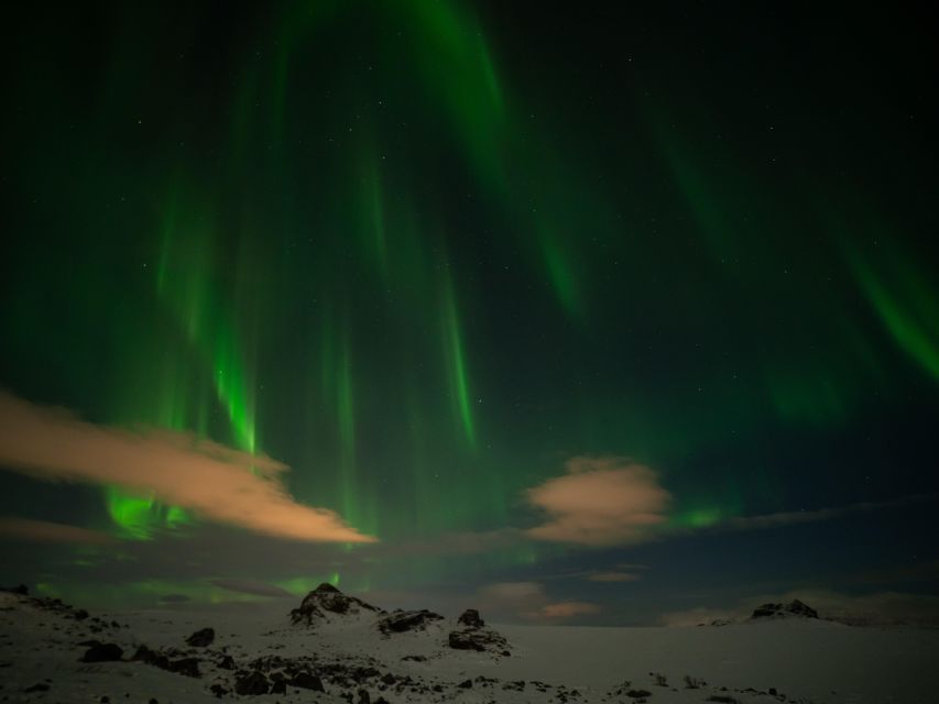 From Reykjavik: Northern Lights Tour with Hot Cocoa & Photos - The first secret stop: finding darkness beyond Reykjavik